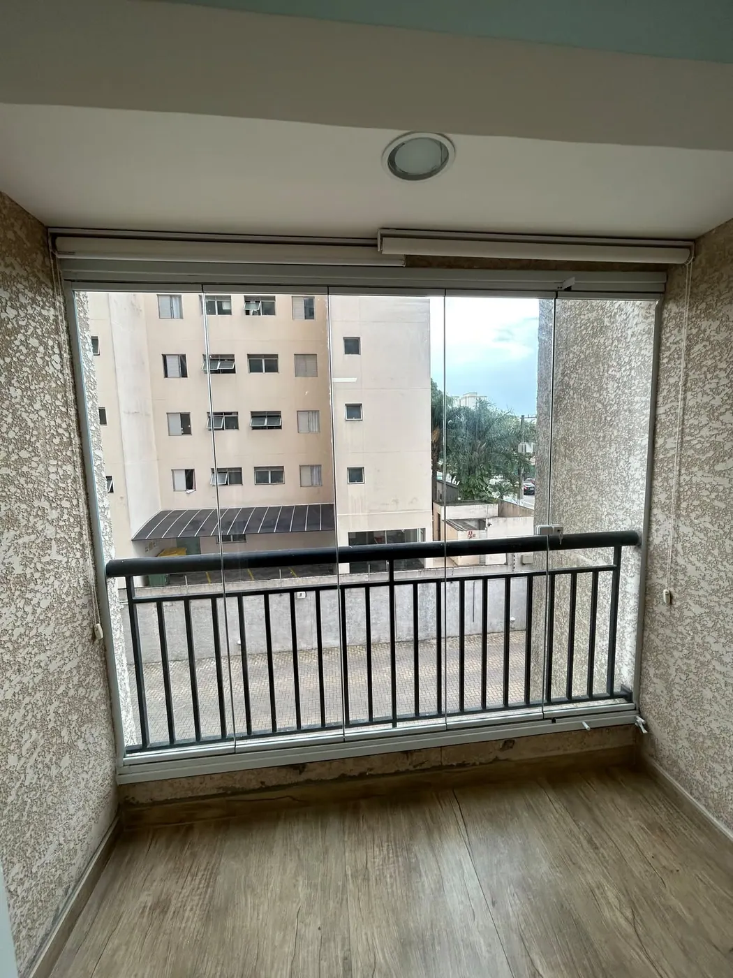 Sacada com fechamento de vidro e vista da cidade